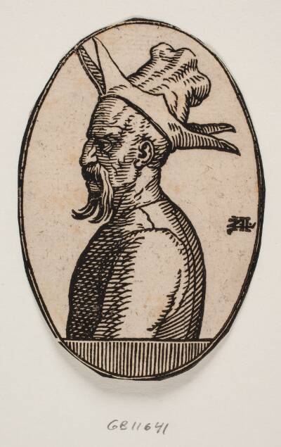 Oval medaljon med brystbillede af mand med hængende moustache og hat med fire flapper