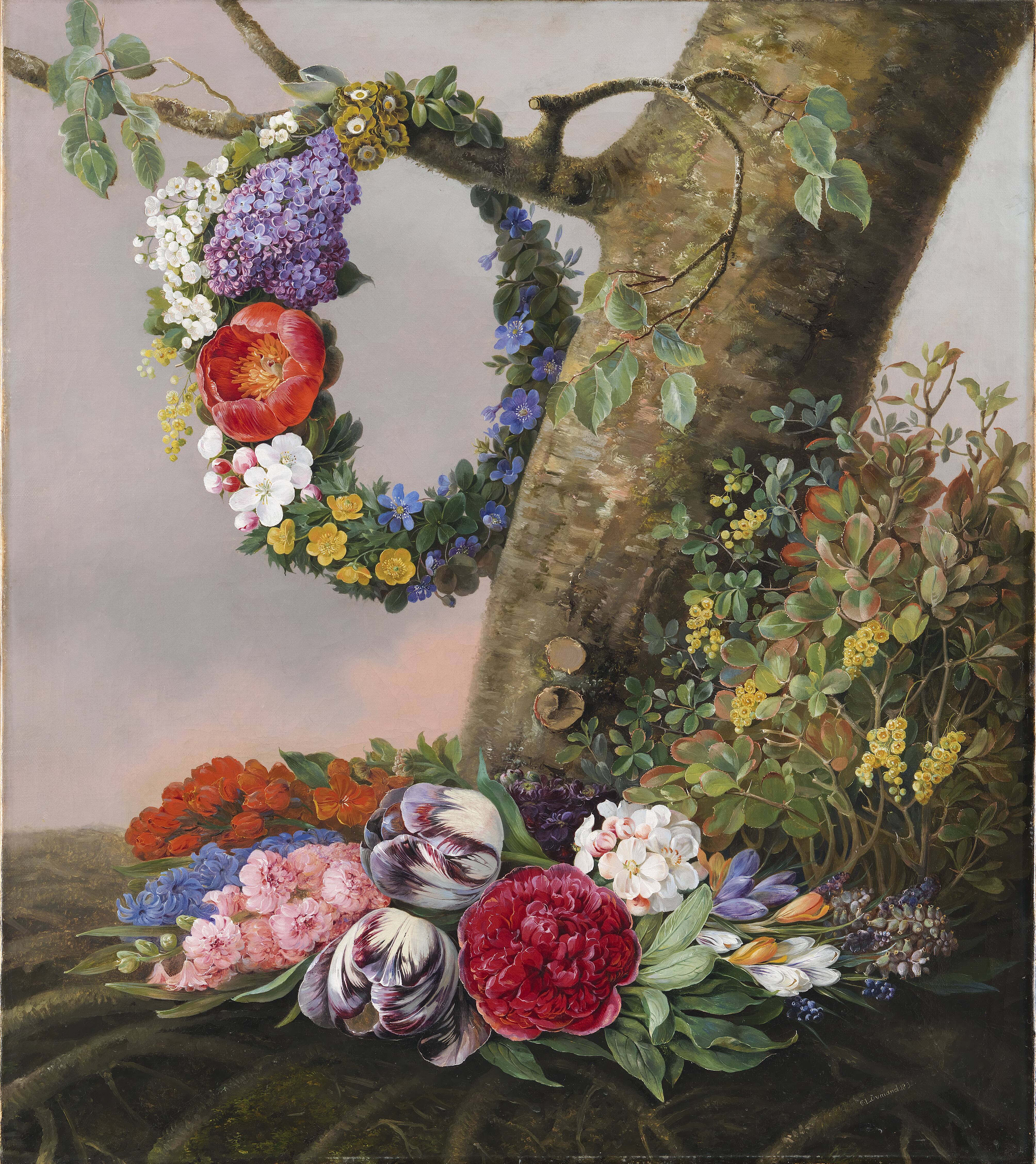 En buket blomster ved foden af et træ. På en gren hænger en blomsterkrans
